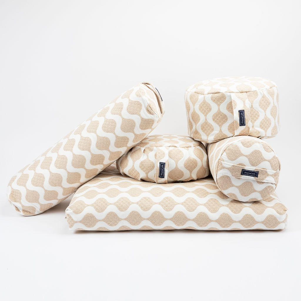 Set of beige and white patterned meditation cushions on a white background