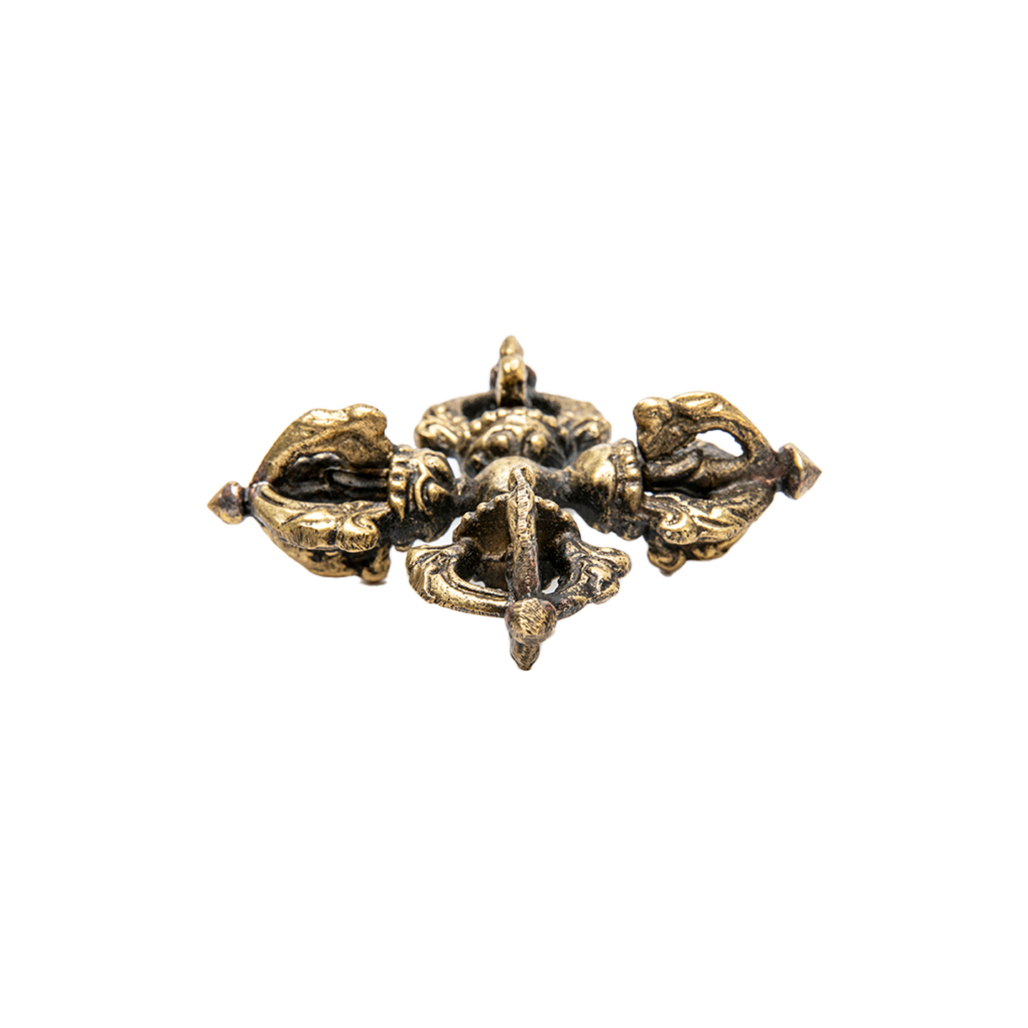 Side angle of the Visva Vajra (Double Dorje). It lays flat against a solid white backdrop with one of the points facing directly into the camera.