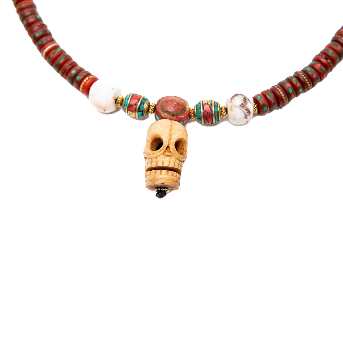 Close up of the skull pendant on a solid white backdrop.