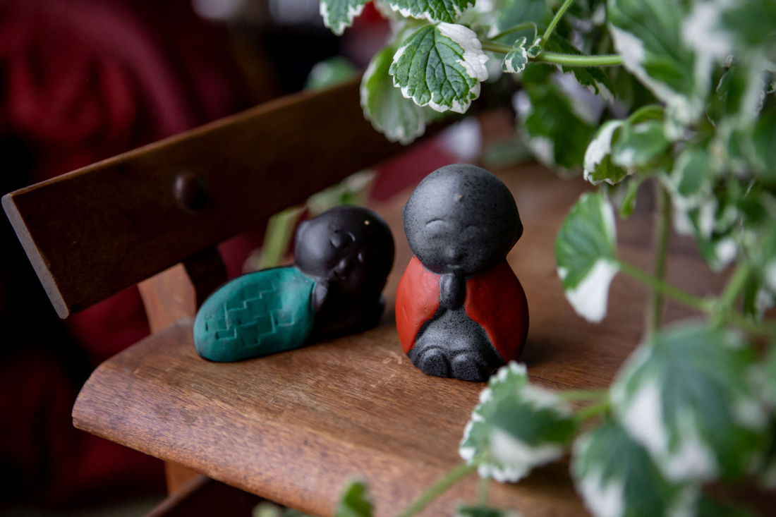 Jizo statues sitting on wooden table