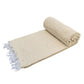 Rolled beige towel with white fringes on a white background