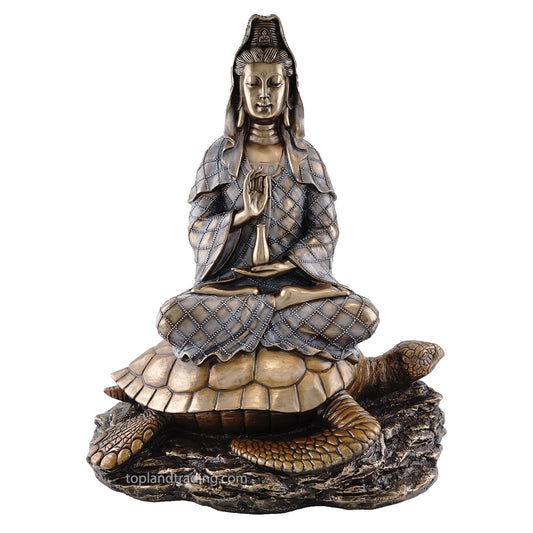 Cold cast bronze statue of Quan Yin seated on a turtle with a crescent moon symbol in the background.
