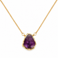 A gold chain necklace featuring a raw, irregular-cut purple amethyst geode pendant in a textured gold bezel setting, shown against a plain white background.