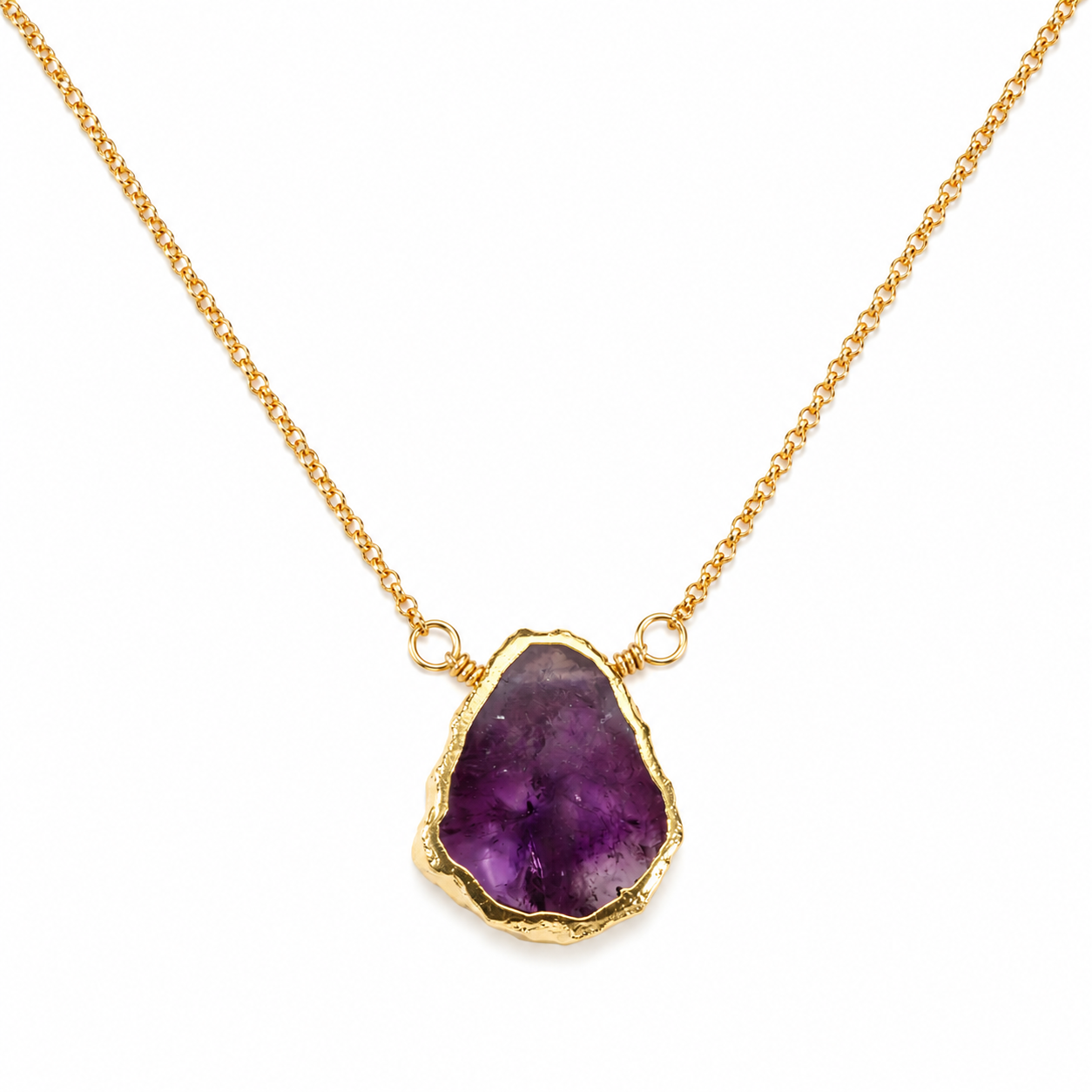 A gold chain necklace featuring a raw, irregular-cut purple amethyst geode pendant in a textured gold bezel setting, shown against a plain white background.