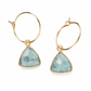 A pair of gold hoop earrings with triangular bezel-set light blue aquamarine gemstones, shown on a clean white background.