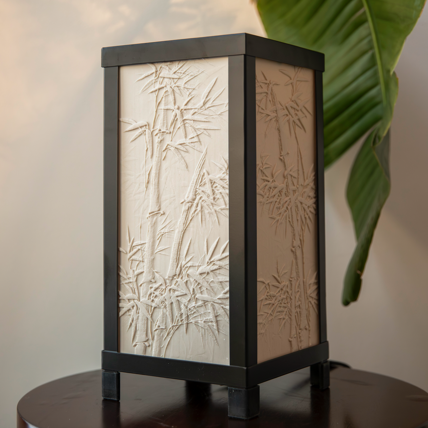 Decorative lamp with bamboo pattern on a wooden surface