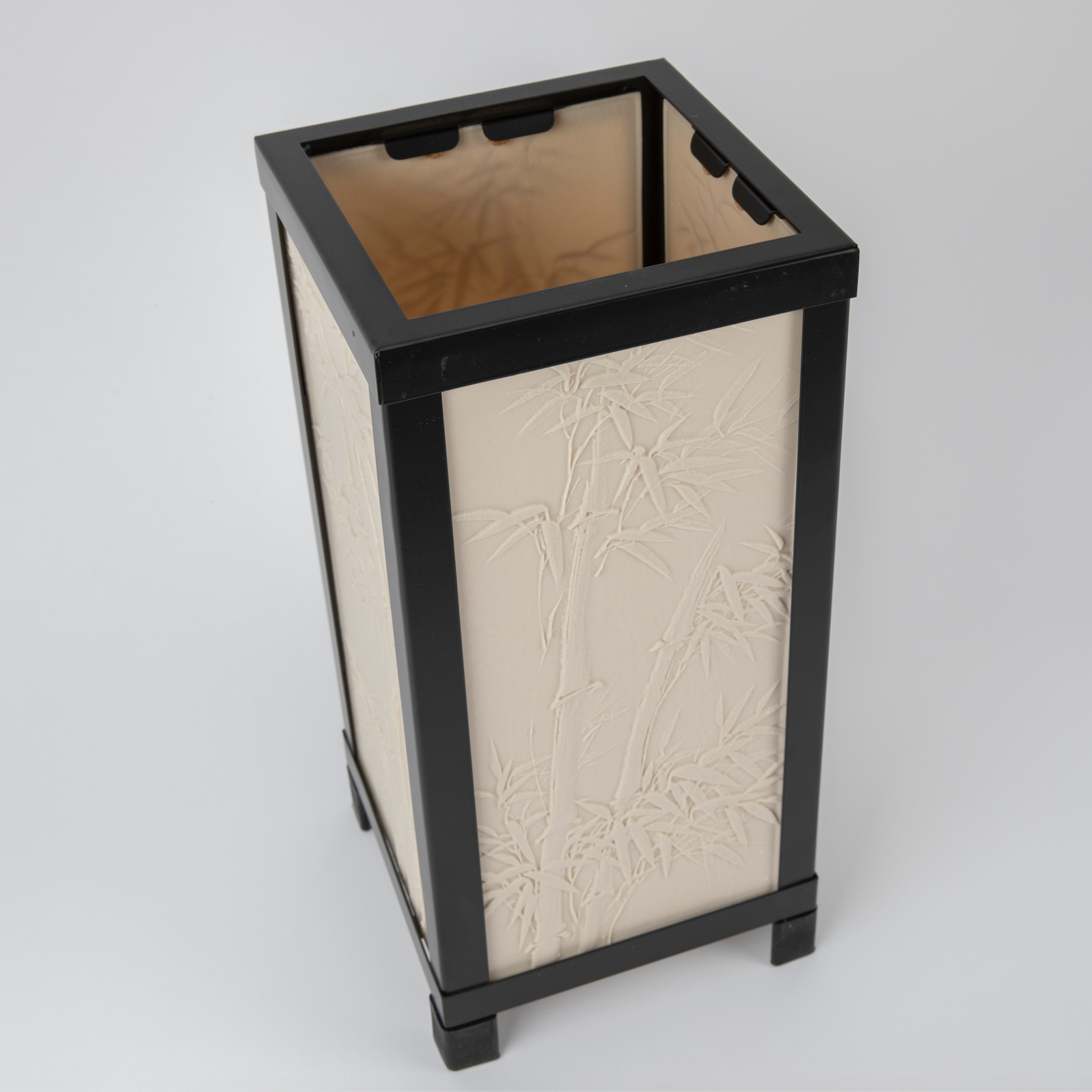 Decorative lamp with black frame and beige textured design on a white background