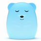 A light blue bear-shaped lamp or night light with a sleeping face, shown on a clean white background.