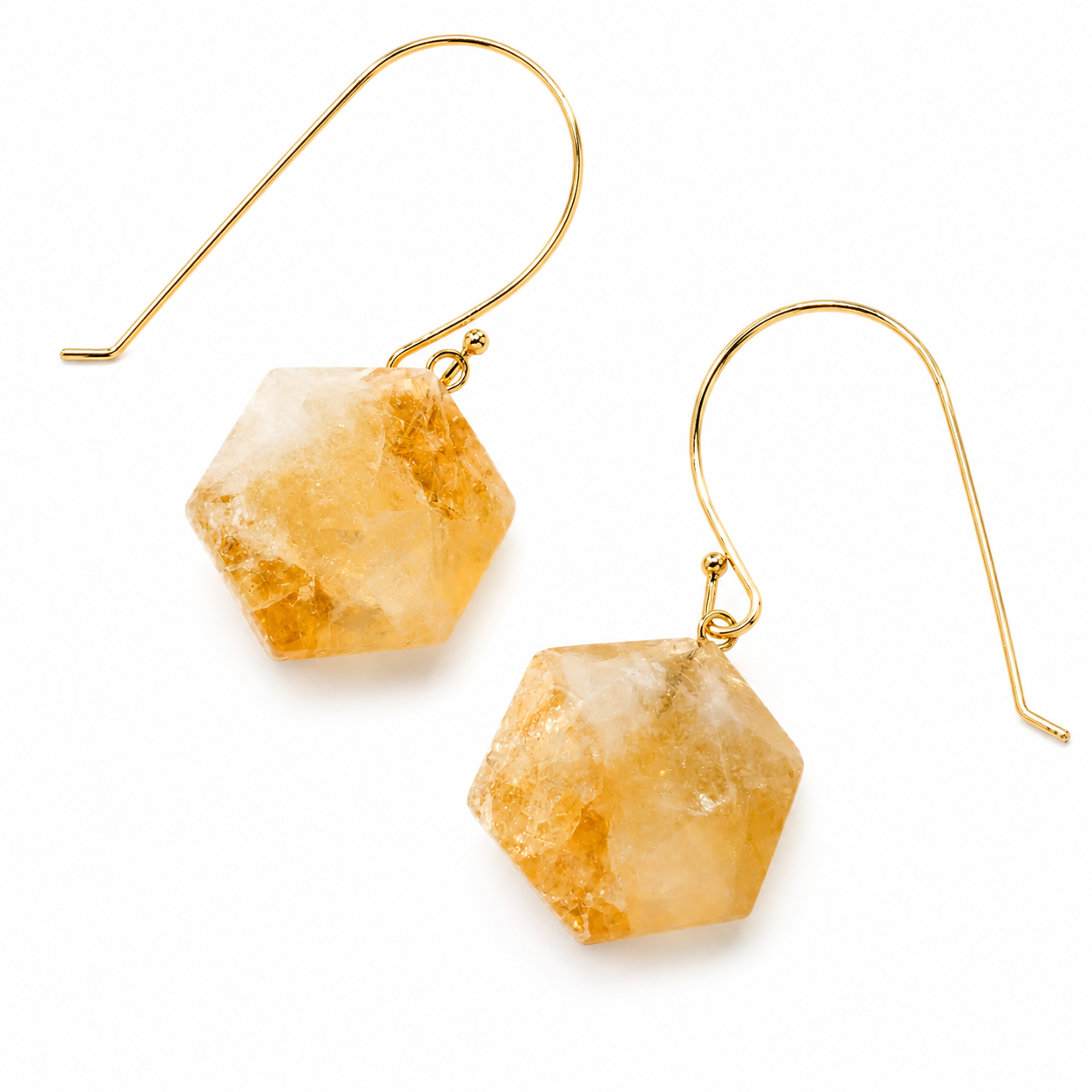 A pair of gold wire hook drop earrings with faceted, hexagonal natural citrine crystals, shown on a clean white background.