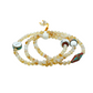 Beaded mala with decorative elements on a white background