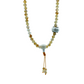 Mala with citrine stones and a tassel on a light gray background