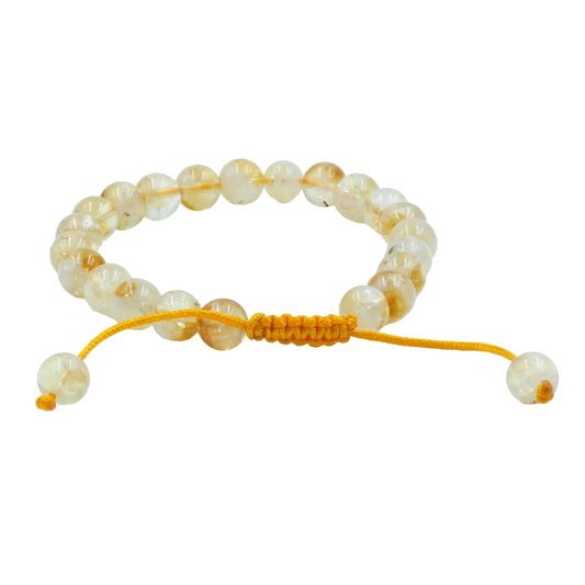 Beaded mala bracelet with yellow cord on a white background