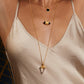 Model wearing three necklaces.