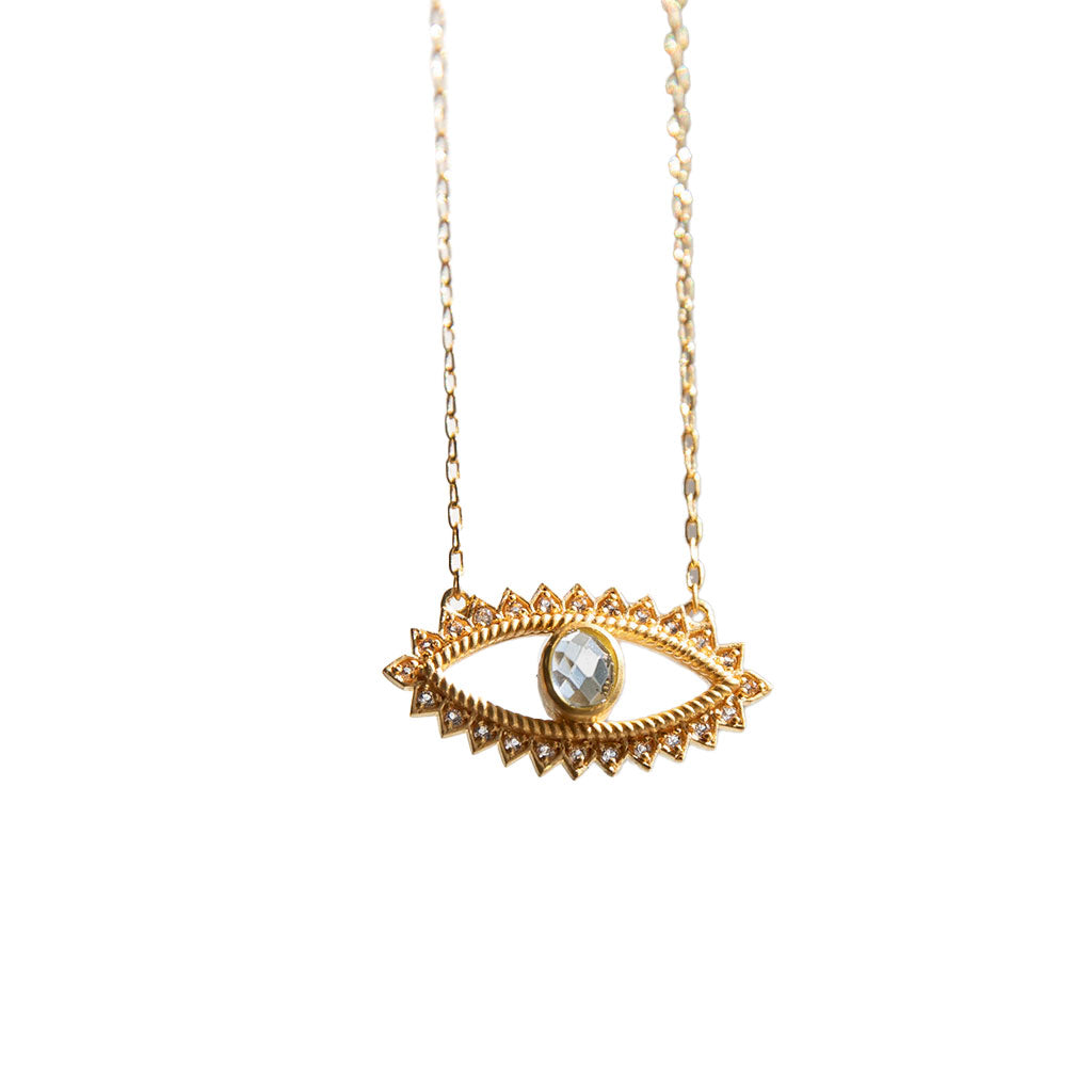 Gold necklace with eye pendant on a white background.