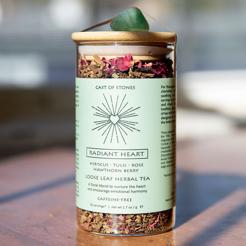 Herbal tea packaging with visible herbs on a wooden surface