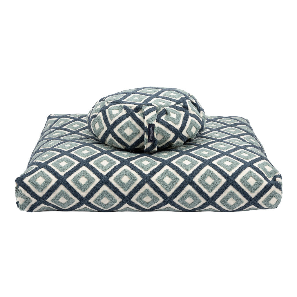 Patterned cushion and ball on a white background
