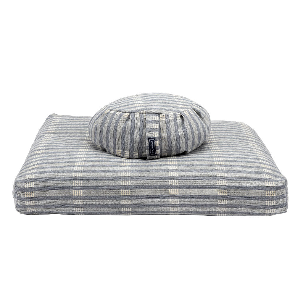 Gray striped pet bed with a round cushion on a white background