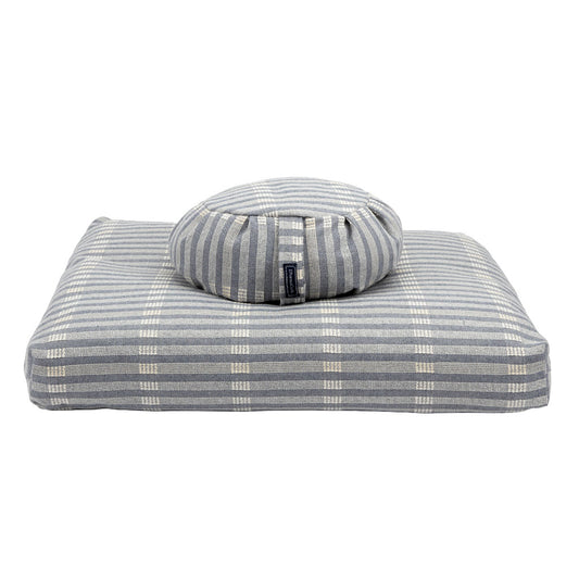 Gray striped pet bed with a round cushion on a white background