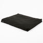 A black rectangular floor cushion or bean bag chair with a matte fabric finish, shown at an angle on a plain white background.