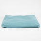 A rectangular, low-profile floor cushion in a light teal blue fabric, photographed against a seamless white studio background.