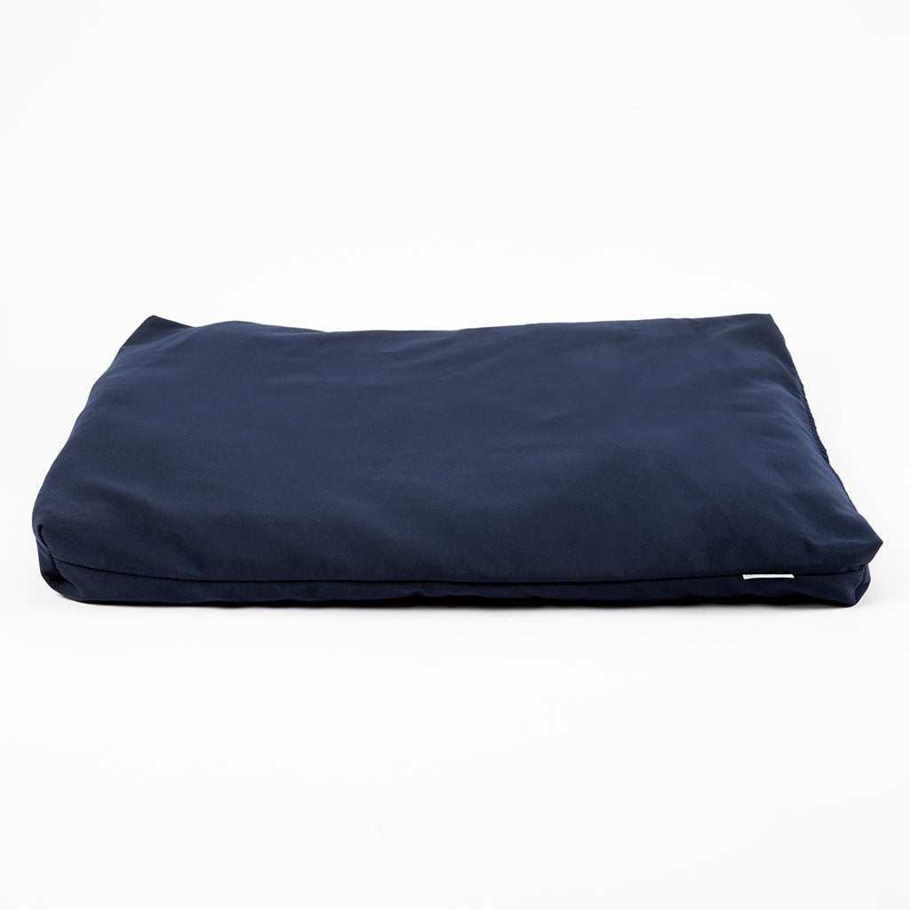 A navy blue rectangular cushion or pet bed with a soft, padded appearance, photographed on a clean white background.