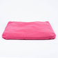 A bright pink rectangular cushion or pillow, folded slightly at the edges, photographed on a seamless white background.