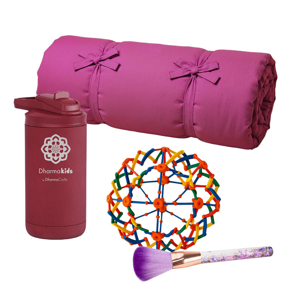 Pink rolled-up yoga mat, pink bottle with logo, colorful geometric ball, and purple makeup brush on a white background.