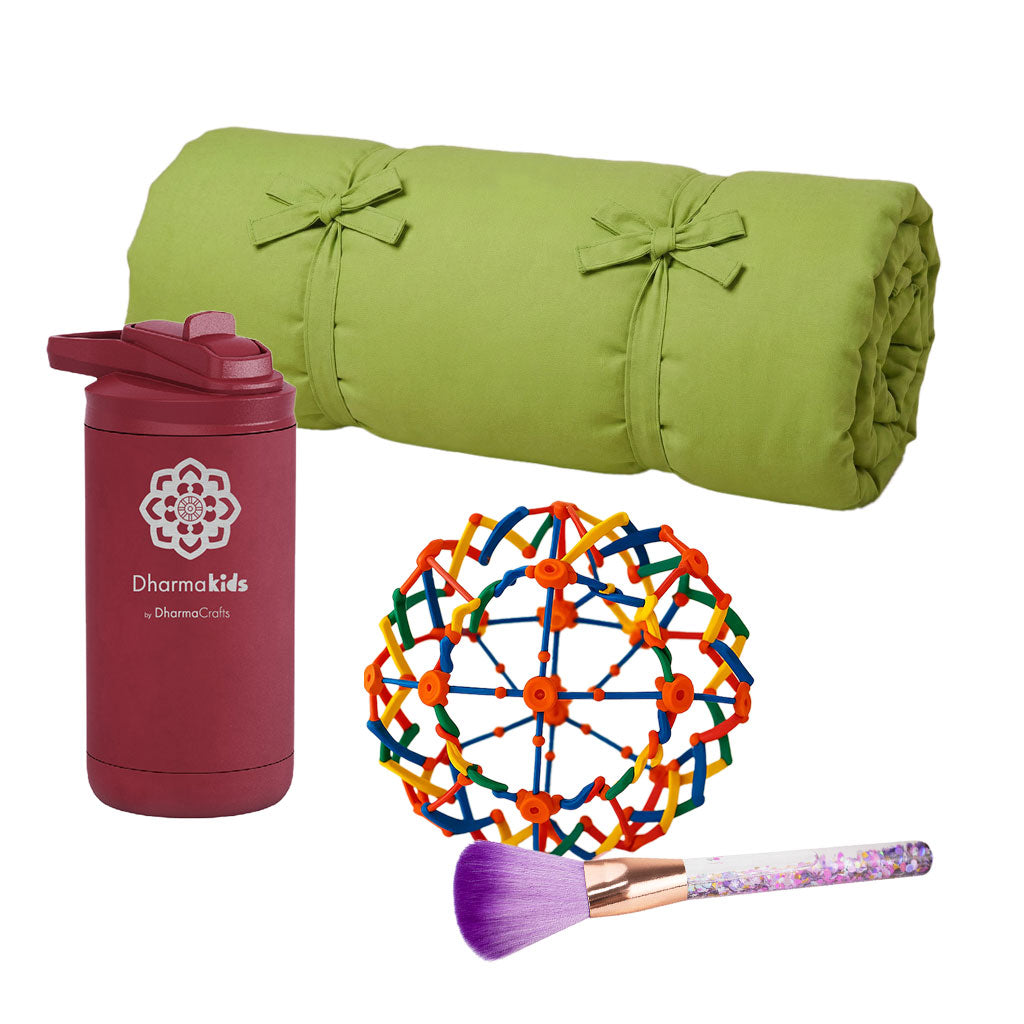 Green rolled-up yoga mat, maroon tumbler with logo, colorful ball, and makeup brush on a white background