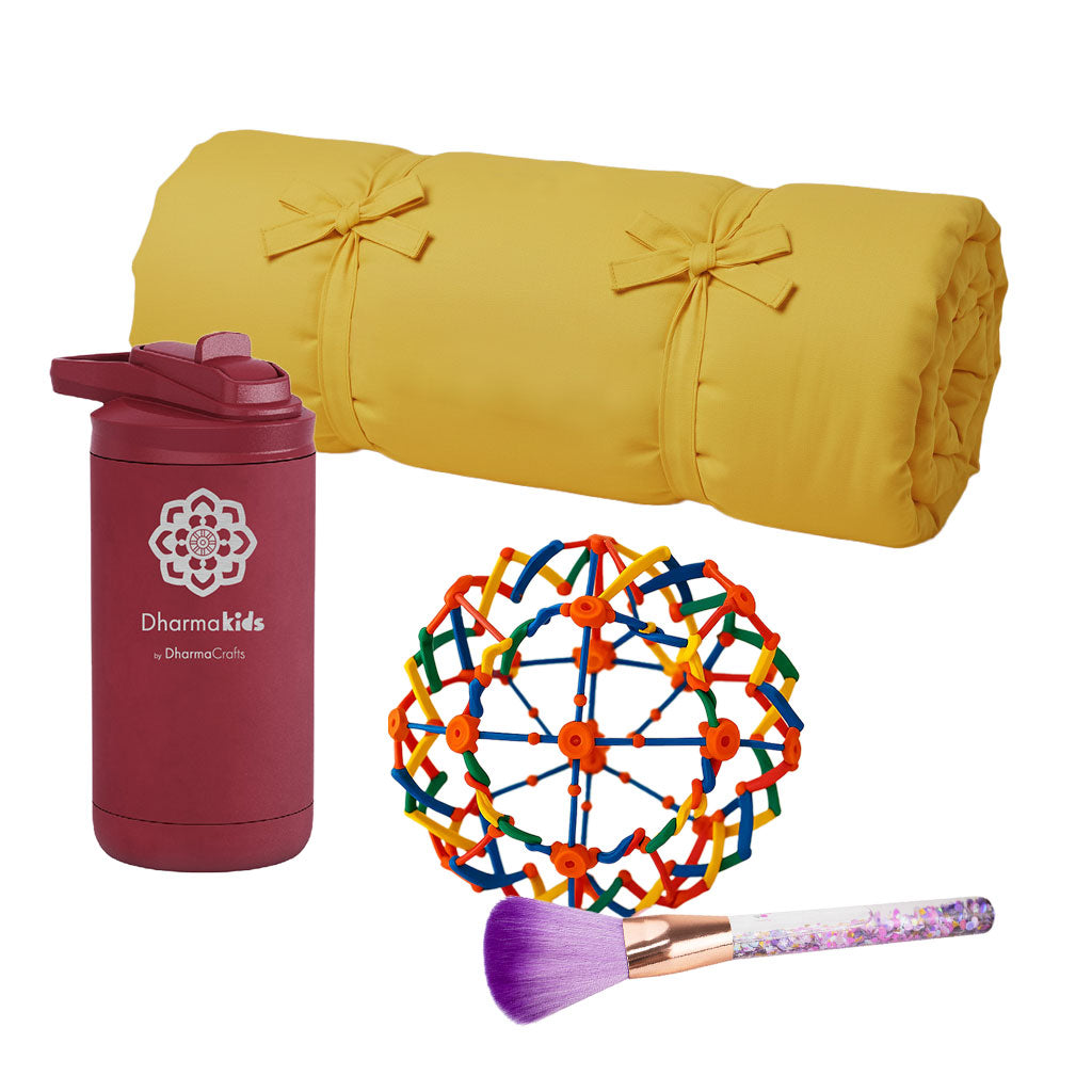Yellow rolled-up yoga mat, maroon tumbler with logo, colorful ball, and makeup brush on a white background