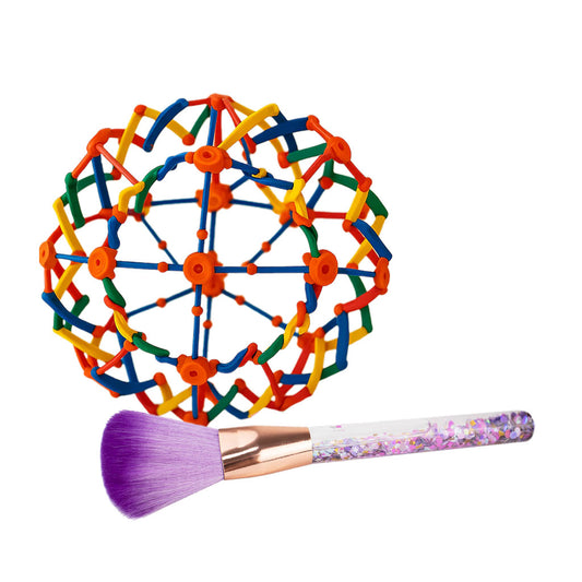Colorful geometric ball and makeup brush on a white background