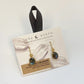 Luna Norte earrings with labradorite stones on a branded card.
