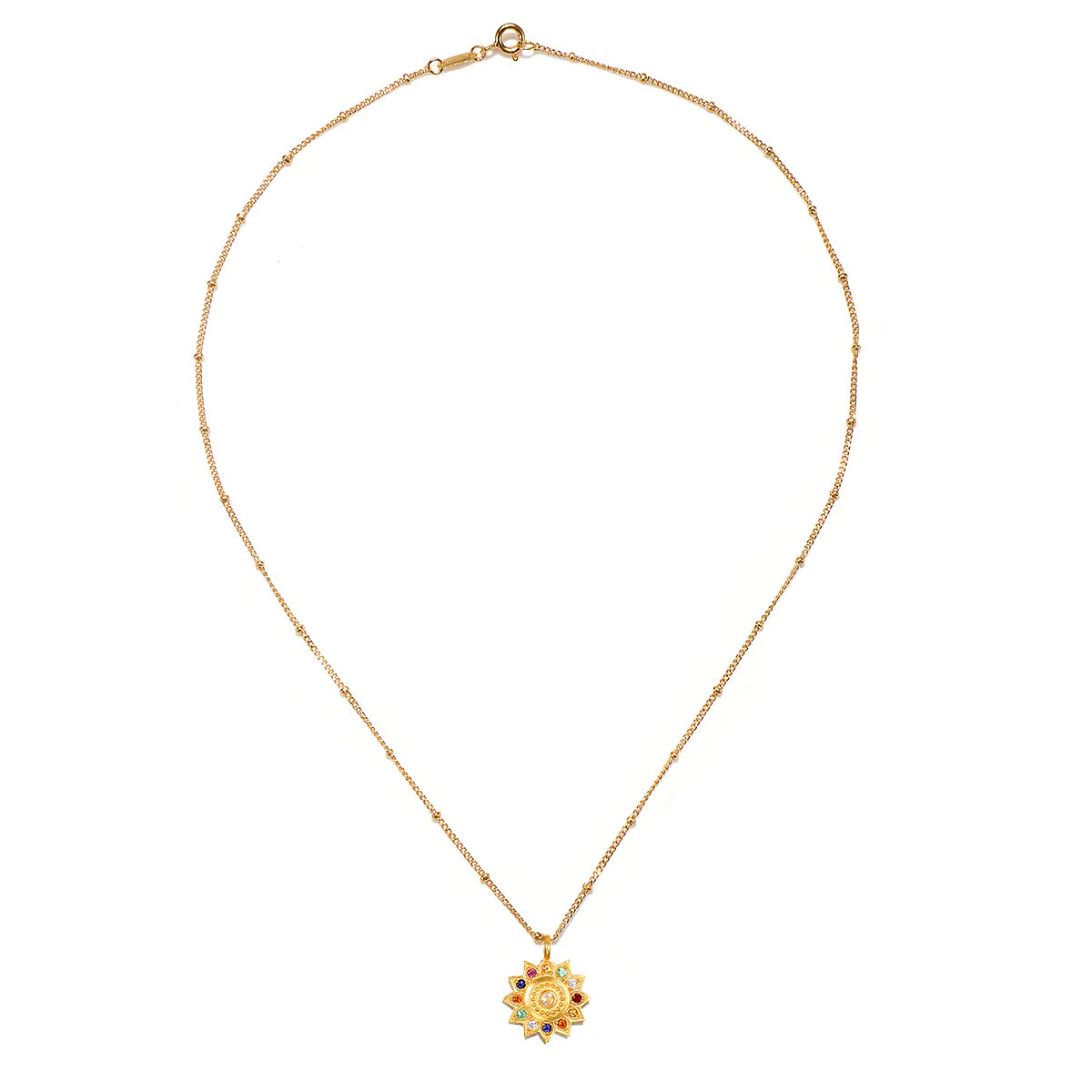 Gold necklace with a sun pendant on a white background.