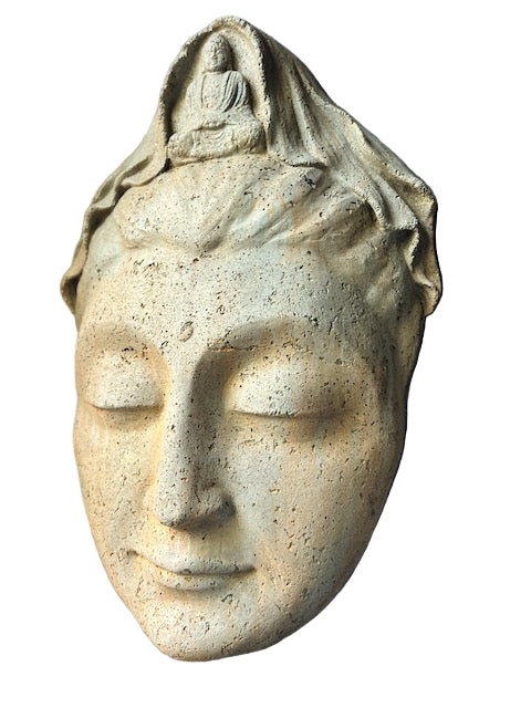 Stone sculpture of a face with a small figure on top against a gray background