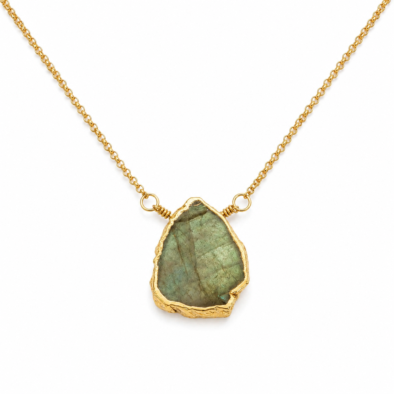 A gold chain necklace featuring a raw, irregular-shaped green labradorite stone pendant with a textured gold border, shown on a clean white background.