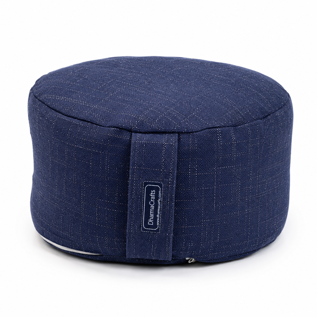 A navy blue fabric meditation cushion with a subtle grid pattern and a vertical fabric strap featuring a 'DreamCrafts' brand label, set against a plain white background.