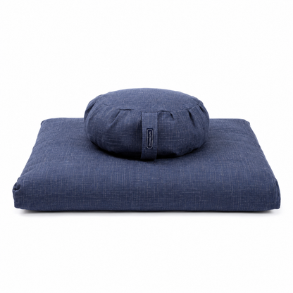 A navy blue meditation cushion set featuring a square floor cushion and a round bolster pillow, both made from a textured woven fabric, shown on a plain white background.