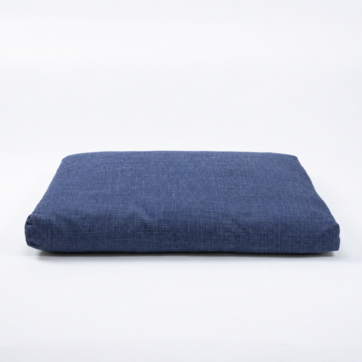 A rectangular floor cushion in a textured navy blue fabric, photographed from a direct overhead angle on a seamless white background.