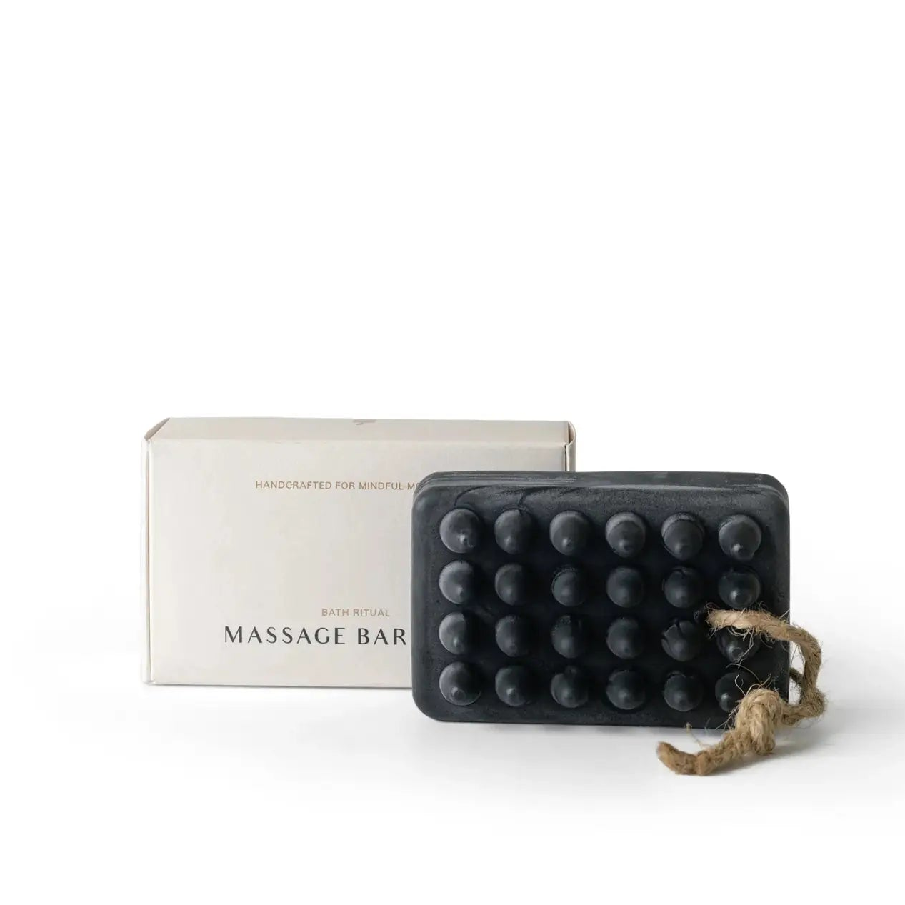 Charcoal massage soap bar with a box on a white background.