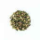 Ball of green herbal tea leaves on a white background
