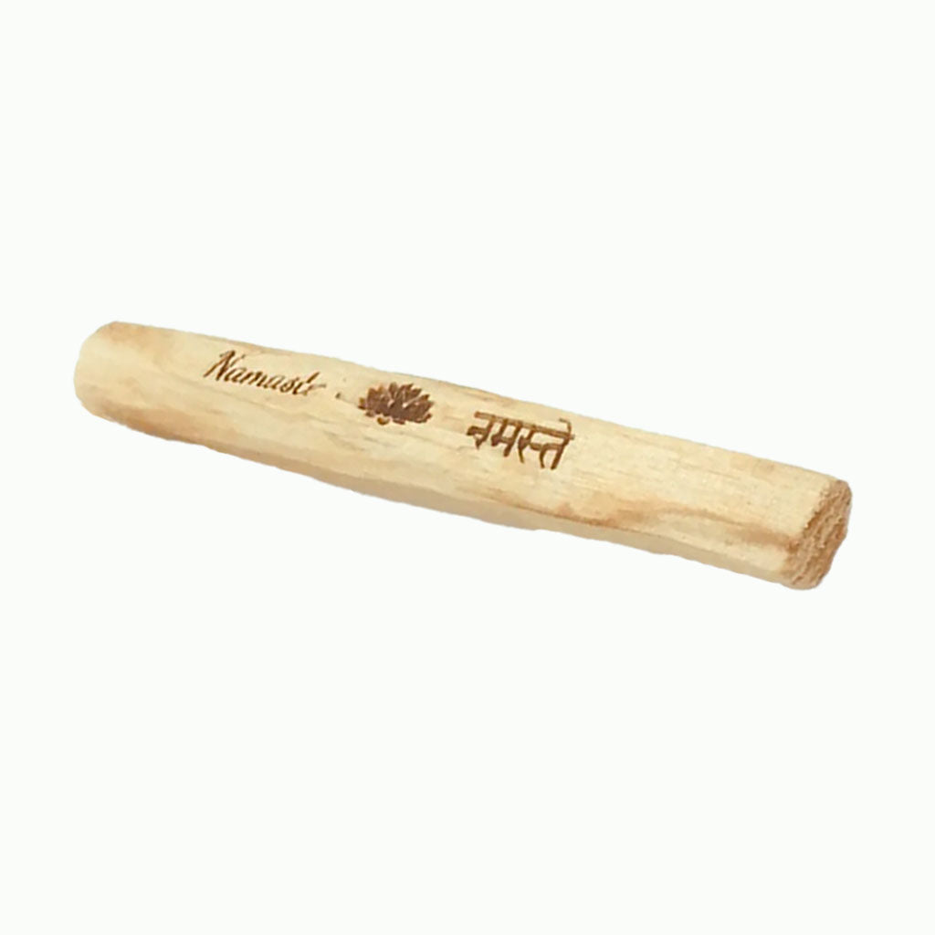 Wooden rolling pin with 'Namasté' engraving on a white background
