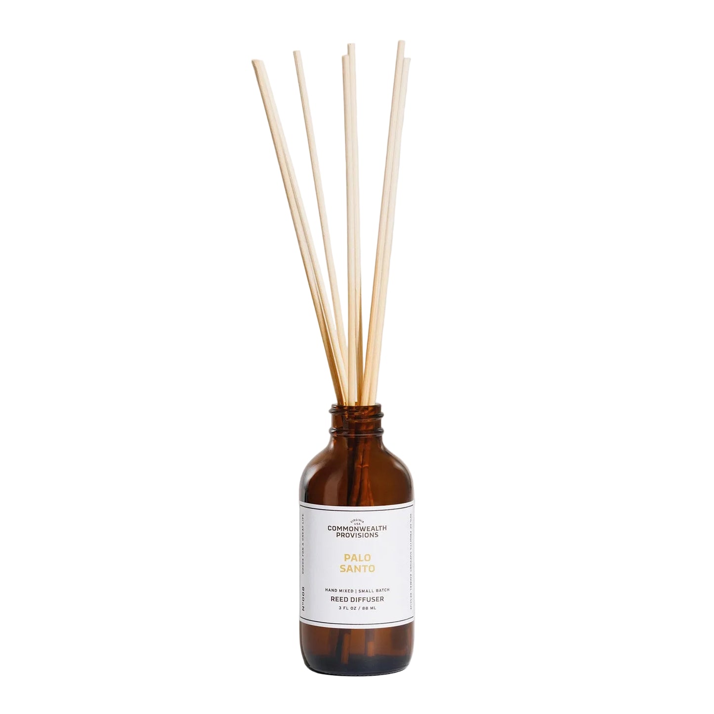 Reed diffuser with wooden sticks in a brown bottle on a light gray background