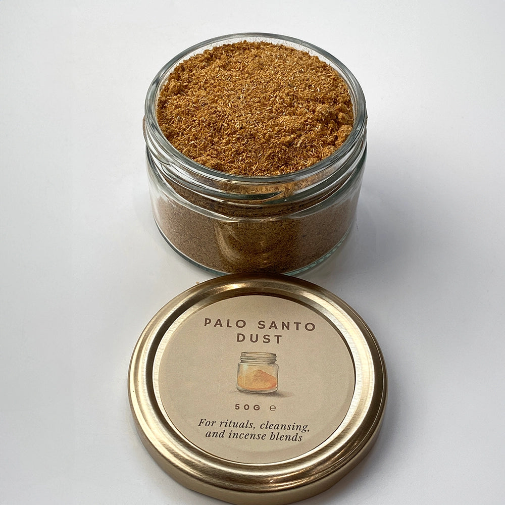 Glass jar of Palo Santo dust with a gold lid on a white background
