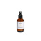 Brown spray bottle with a label on a light gray background