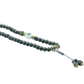 Mala necklace with gray beads and decorative elements on a white background