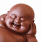 A smiling Buddha figurine in a reddish-brown terracotta color, shown on a plain white background.