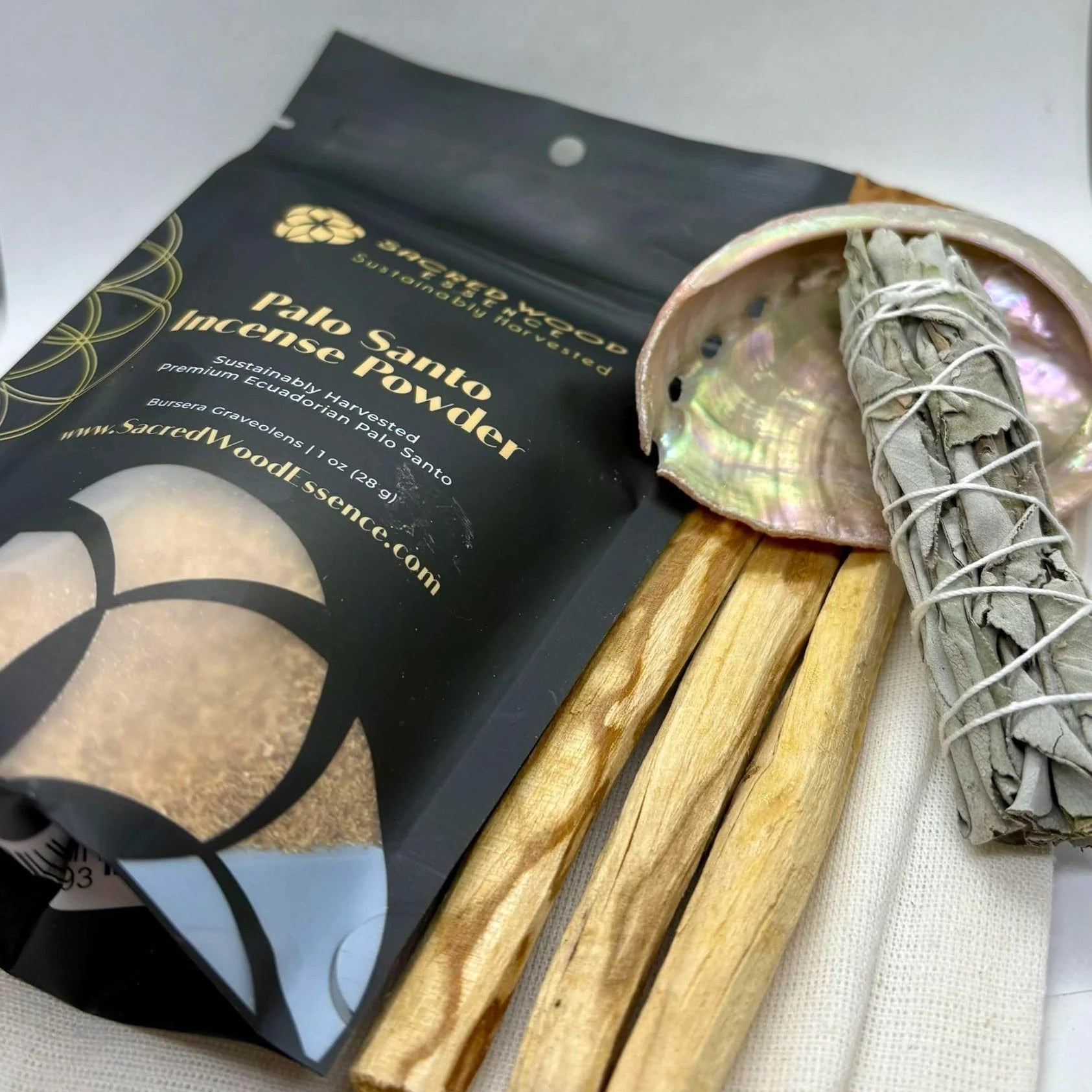 Palo Santo incense sticks and powder with packaging on a light background
