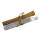 Palo santo and selenite tied together with twine on a white background.