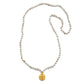 White turquoise mala with gold pendant on white background.