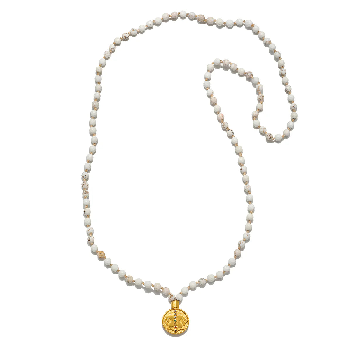 White turquoise mala with gold pendant on white background.