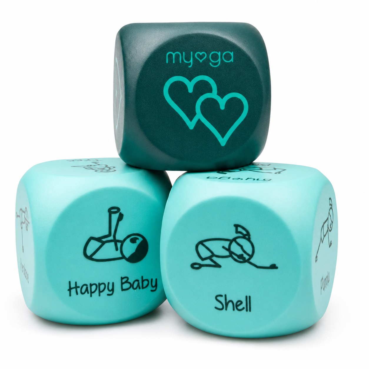 Three custom baby yoga dice in teal and mint green, printed with black line drawings and text including 'my❤❩ga', 'Happy Baby', and 'Shell', arranged on a white background.